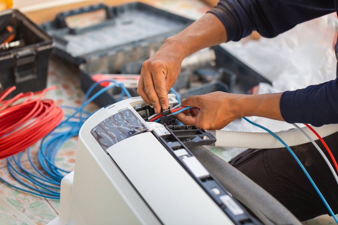 Air conditioning technicians install new air conditioners in homes, Repairman fix air conditioning systems, Male technician service for repair and maintenance of air conditioners